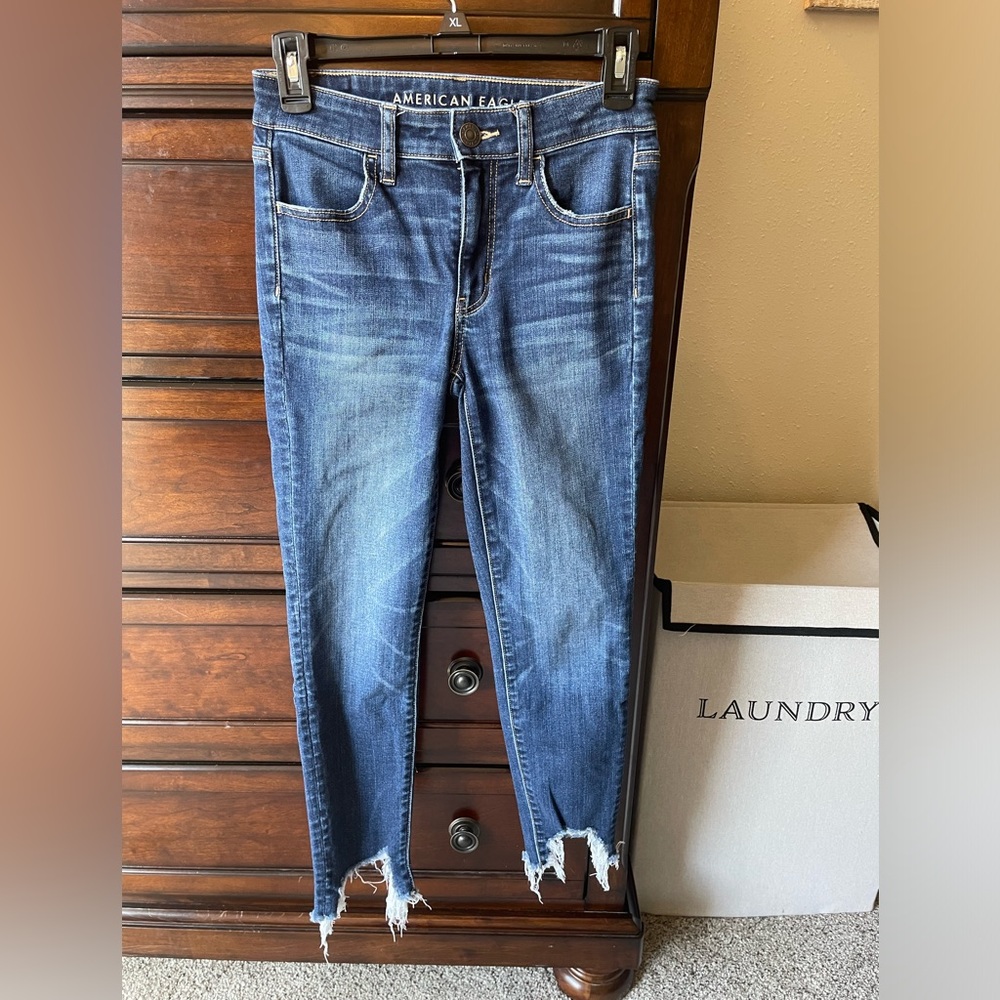 Size 2 mid rise skinny destroyed hem jeans.